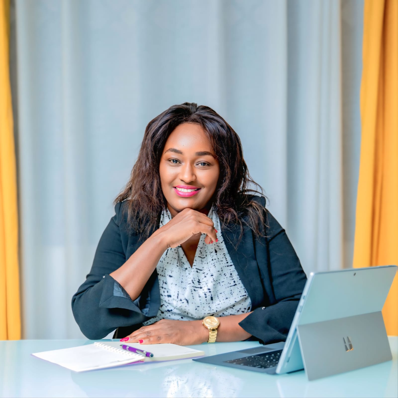 Catherine Gatwiri seated at her desk
